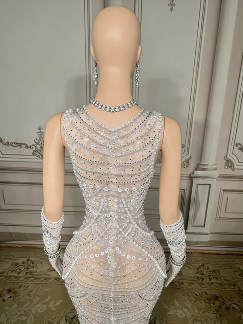 Beaded White Mermaid Gown – High-Neck Sleeveless Style Featuring Open Back Detail and Floor-Sweeping Hemline